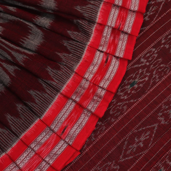 Grey and red Sambalpuri cotton saree draped to show its fall, style, and motif pattern.