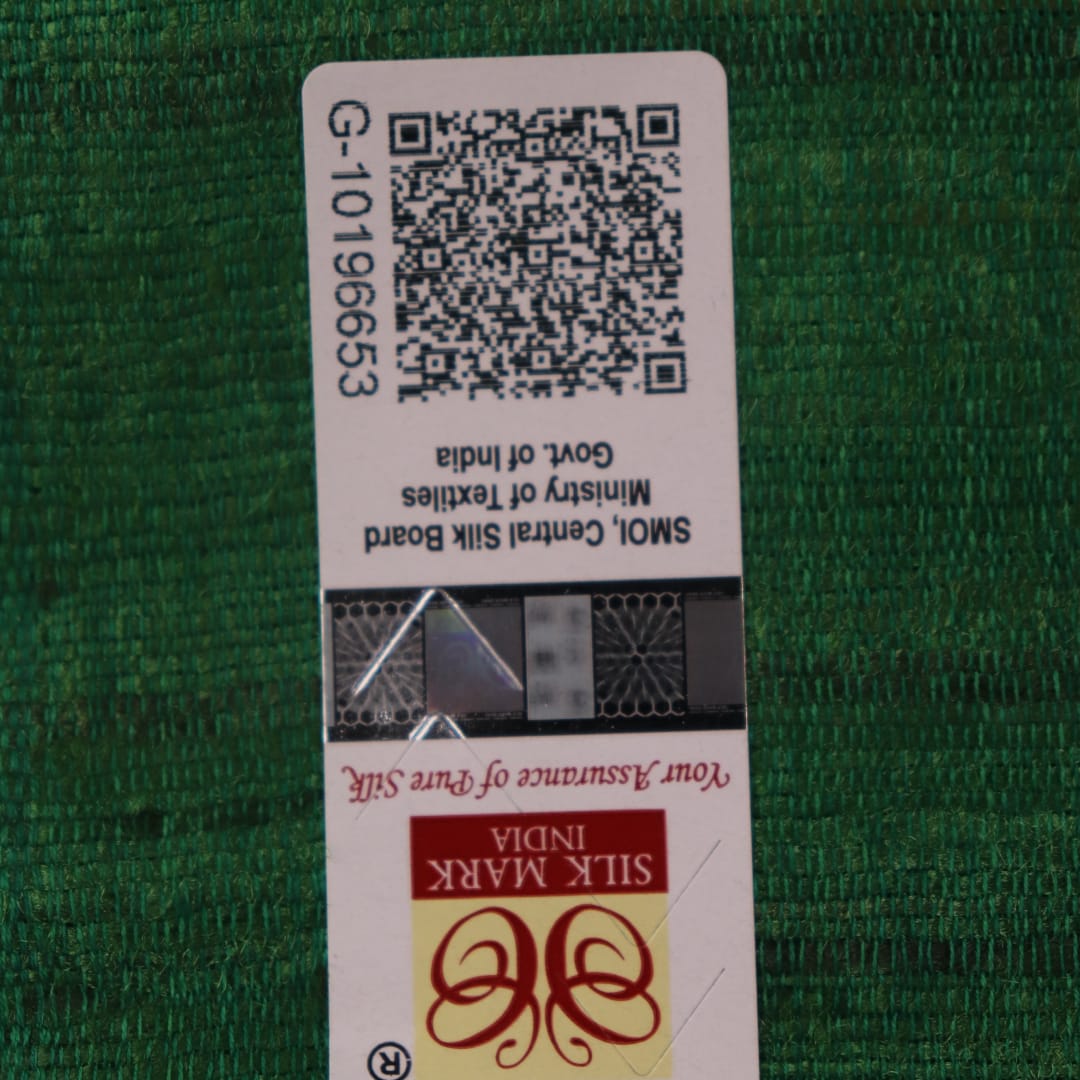 Close-up of plain off-white Tussar silk saree fabric, showing natural slub texture and rust weave.