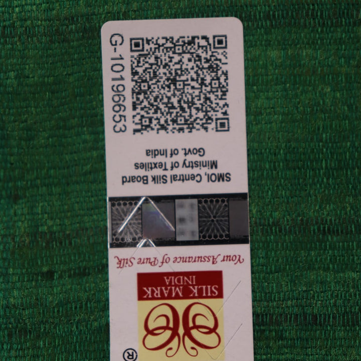 Close-up of plain off-white Tussar silk saree fabric, showing natural slub texture and rust weave.