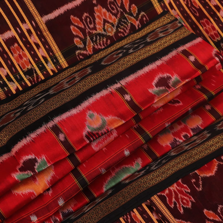 Red and black silk Khandua saree with Nabakothi pattern, styled or draped view showing the overall look.