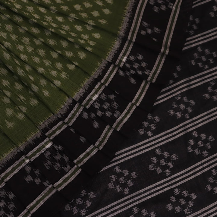 Green and black Sambalpuri cotton saree with motifs, elegantly draped.