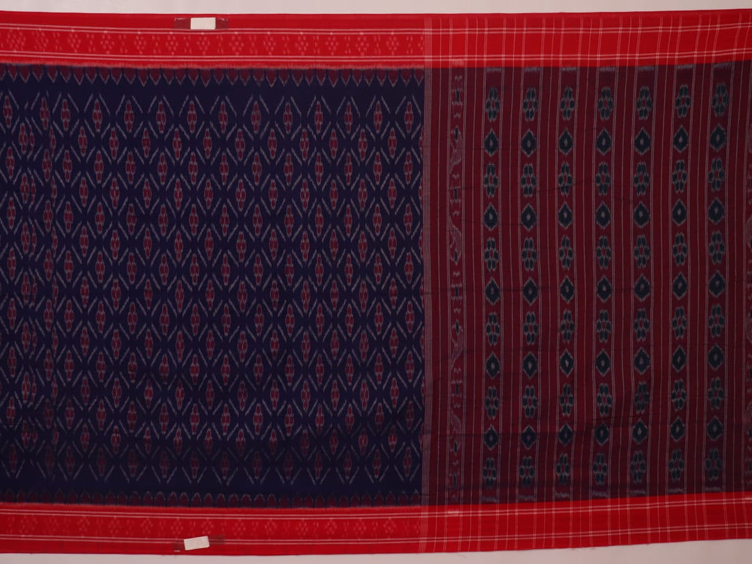 Gracefully draped blue Sambalpuri cotton saree with red motifs, highlighting its design and flow.