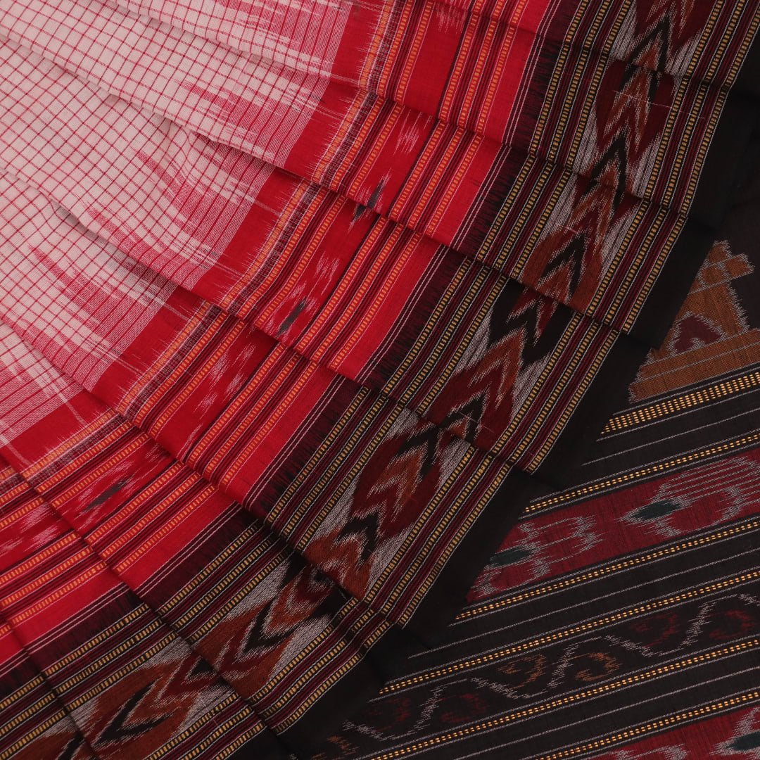 Saree styling: White and black Sambalpuri cotton saree with motifs, draped to showcase the overall look.