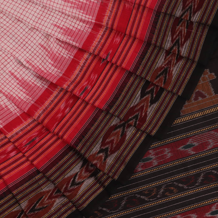 Saree styling: White and black Sambalpuri cotton saree with motifs, draped to showcase the overall look.