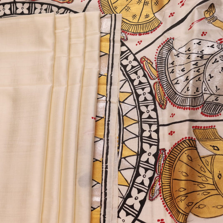 Close-up of white silk Patachitra saree, showcasing the handloom fabric's texture and subtle paint details.