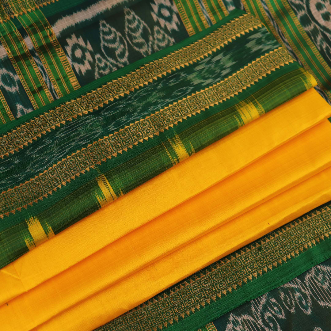 Yellow Khandua silk saree draped, showcasing its simple elegance and the plain body.