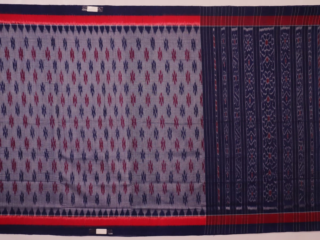 Blue Sambalpuri cotton saree with motifs, gracefully draped.