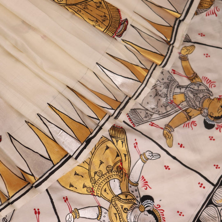 Close-up of white silk Patachitra saree, showcasing the handloom fabric's texture and subtle paint details.