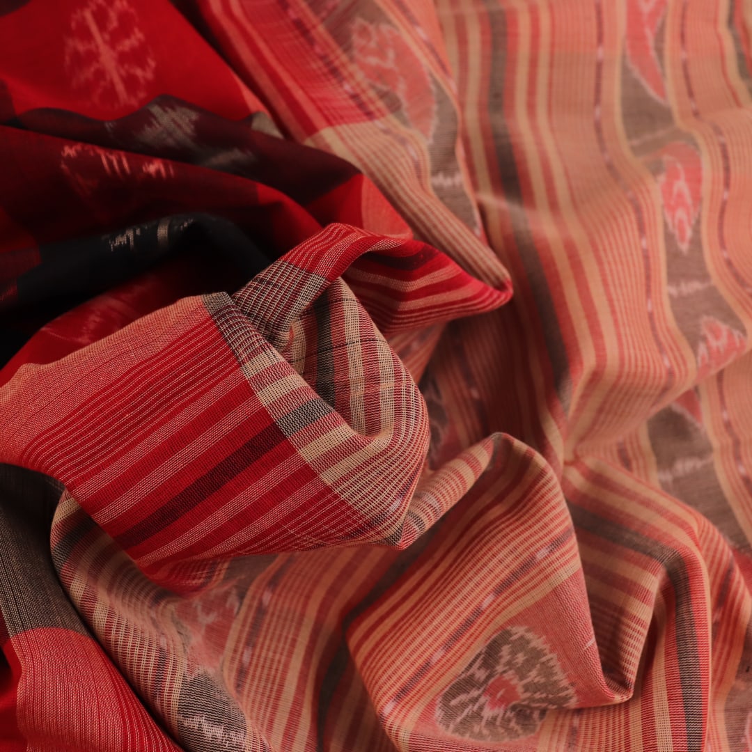 Full product view of a red and cream Sambalpuri cotton saree featuring traditional motifs.