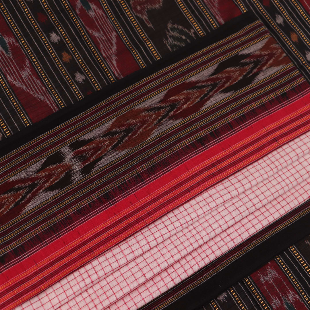 Woman draped in a white and black Sambalpuri cotton saree with motifs.