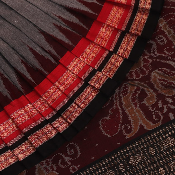 Full view of grey Bomkai cotton saree, featuring black border and butta pattern.