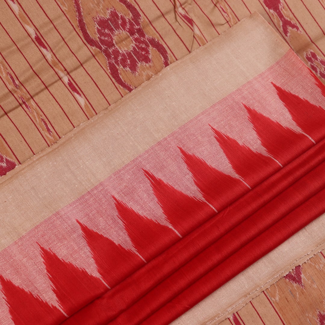 Close-up of plain red and off-white Tussar silk saree fabric texture.