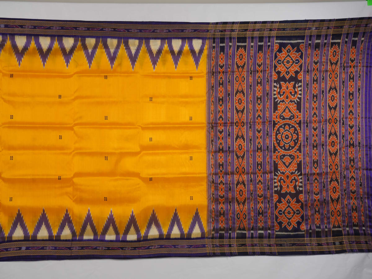 Full styling view of a model draped in a vibrant yellow and blue handloom Khandua silk saree with butta work.