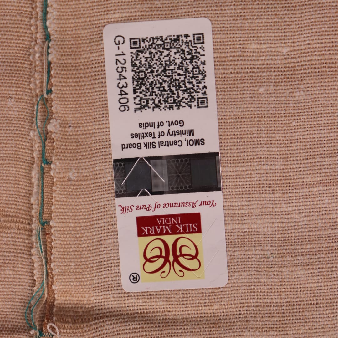 Close-up of the green and off-white plain Tussar silk saree, highlighting its natural slub texture.