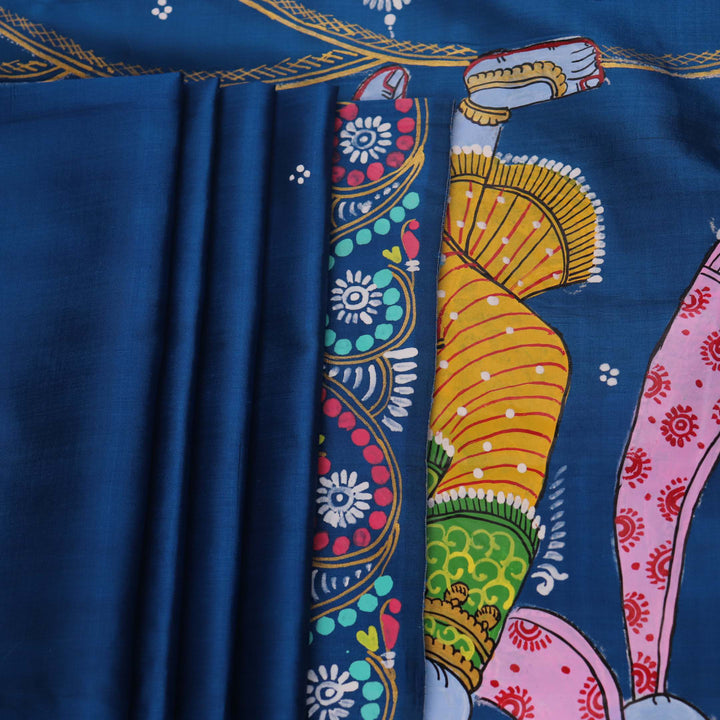 Close-up of the handwoven blue Patachitra silk saree, showcasing the detailed texture of the fabric.