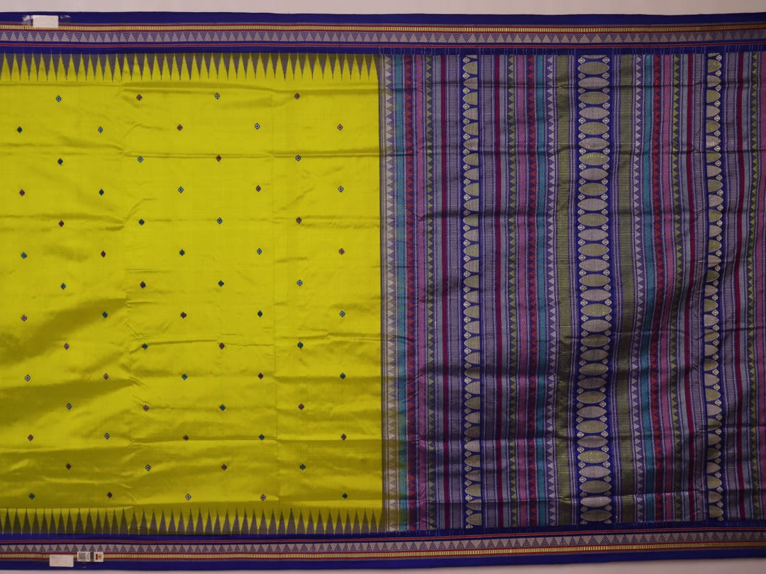 Close-up of green and blue Dongria silk saree fabric texture with butta pattern.