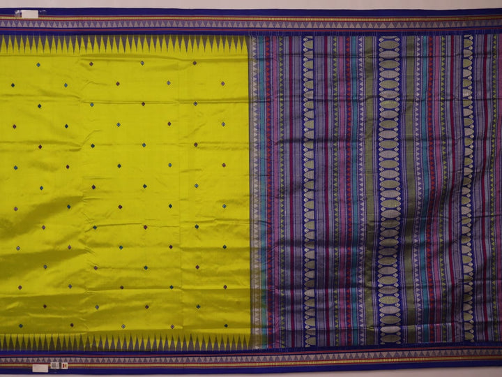 Close-up of green and blue Dongria silk saree fabric texture with butta pattern.