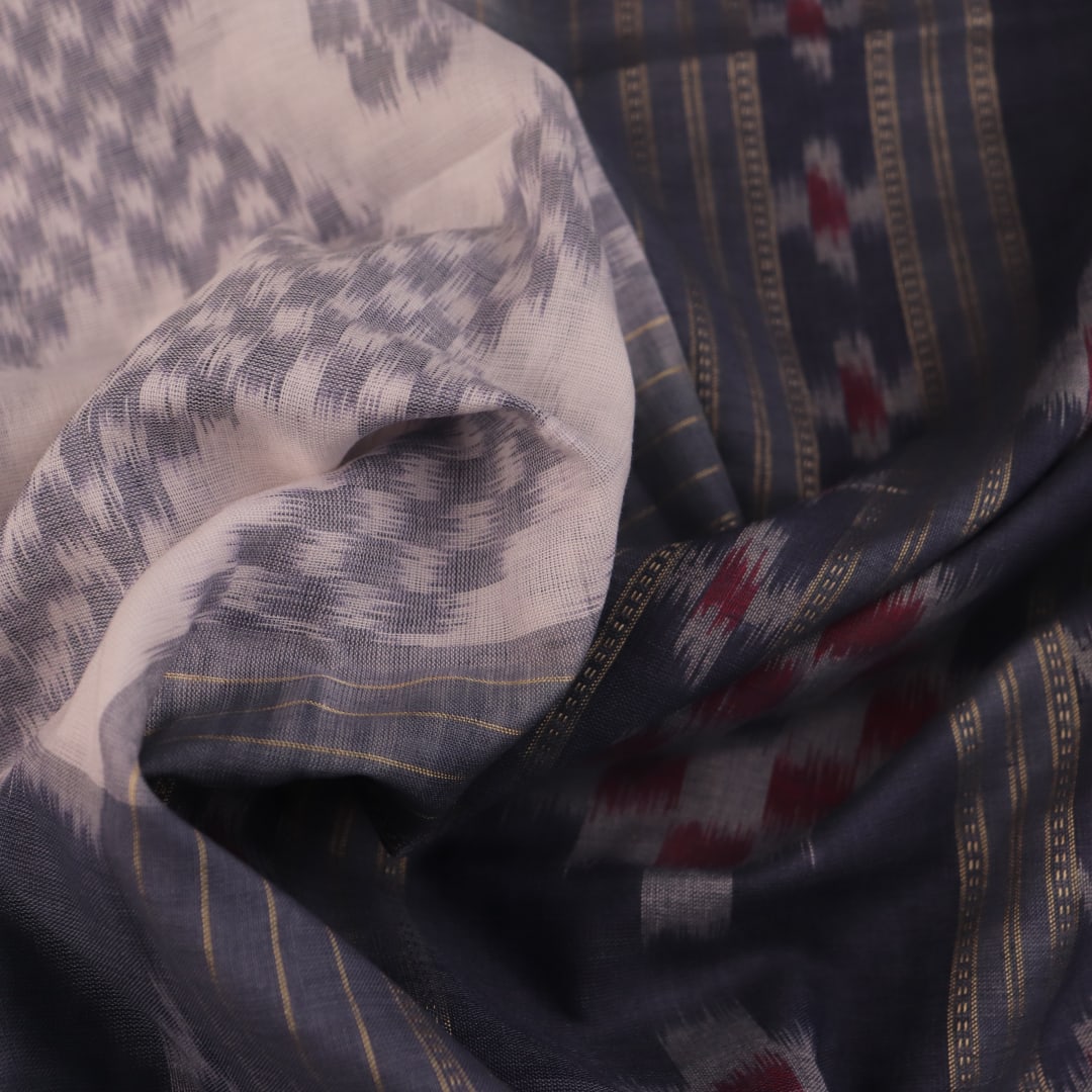 Draped view of white and grey Sambalpuri cotton saree with motifs.