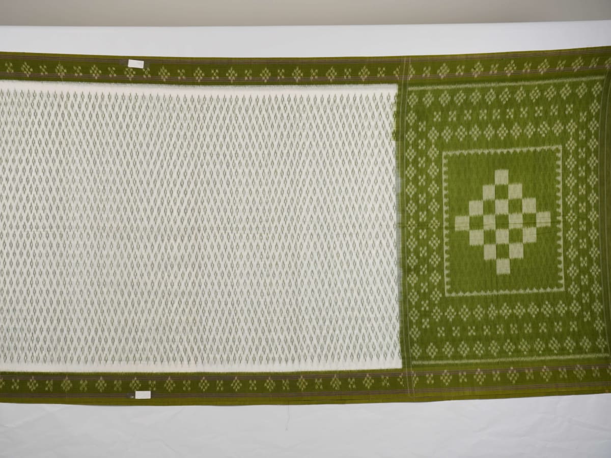 Model wearing a white and green Sambalpuri cotton saree, demonstrating the elegant drape and handloom motifs.