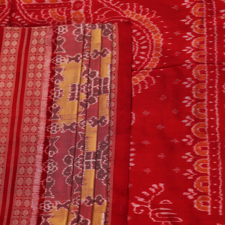 Close-up of multicolored silk Sambalpuri saree fabric showing intricate handloom weave texture.