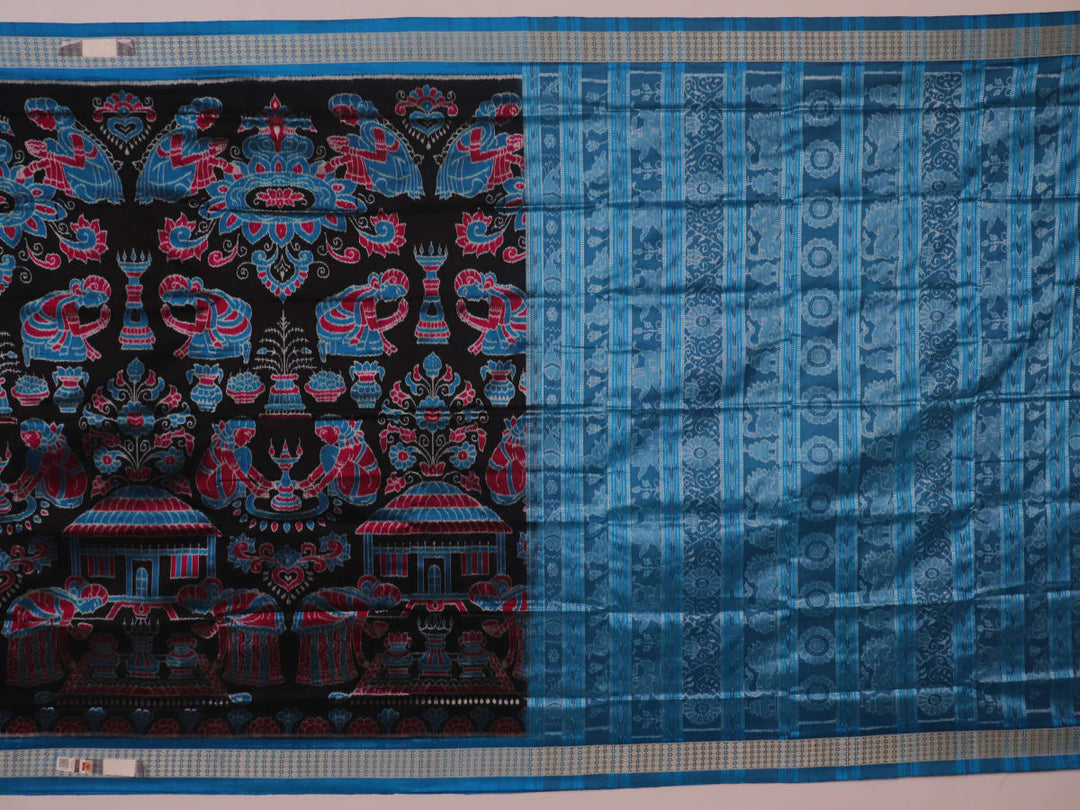 Close-up of black Sambalpuri silk saree fabric texture, showcasing the weave and subtle motif details.