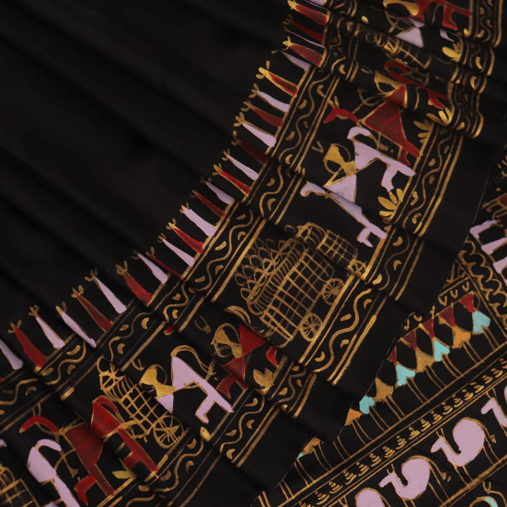 Close-up of the black silk Patachitra saree, showcasing the hand-painted fabric texture.