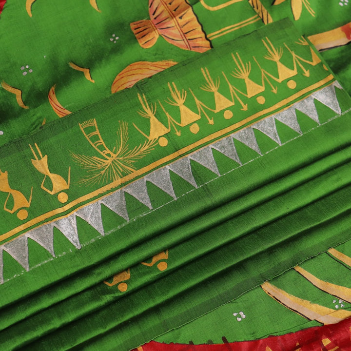 Close-up of green Patachitra silk saree, showcasing the handloom weave and fabric texture.