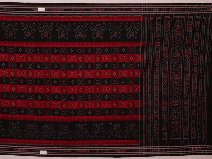 Red and black Sambalpuri cotton saree draped, showcasing overall styling and motifs.