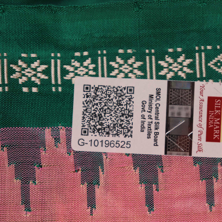 Close-up of the plain woven silk texture of a pink and green Sambalpuri saree.