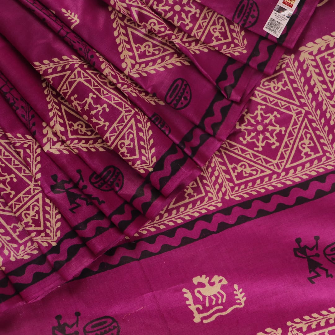Close-up of magenta Tussar silk saree fabric, showing the printed pattern and natural slub texture.