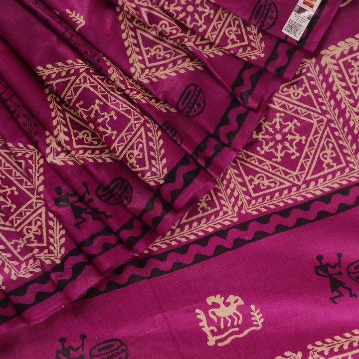 Close-up of magenta Tussar silk saree fabric, showing the printed pattern and natural slub texture.