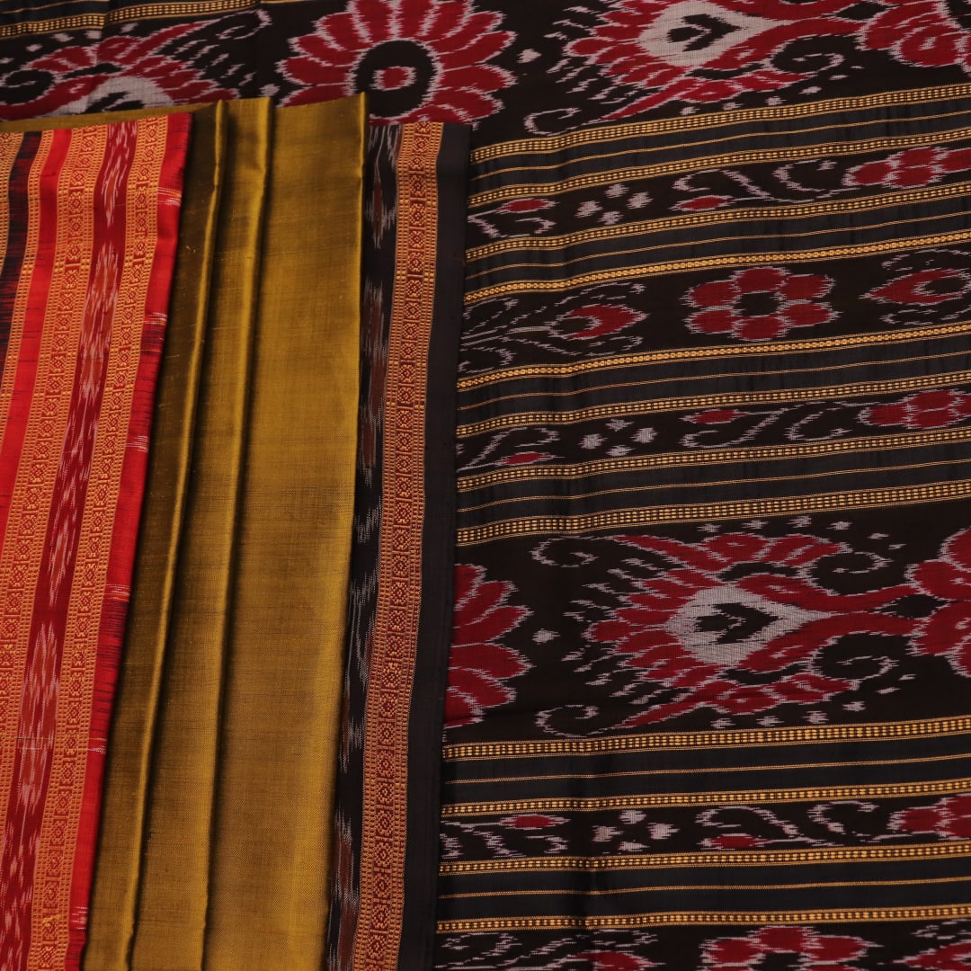 Green and black Khandua silk saree draped; showcasing its butta pattern and elegant fall.