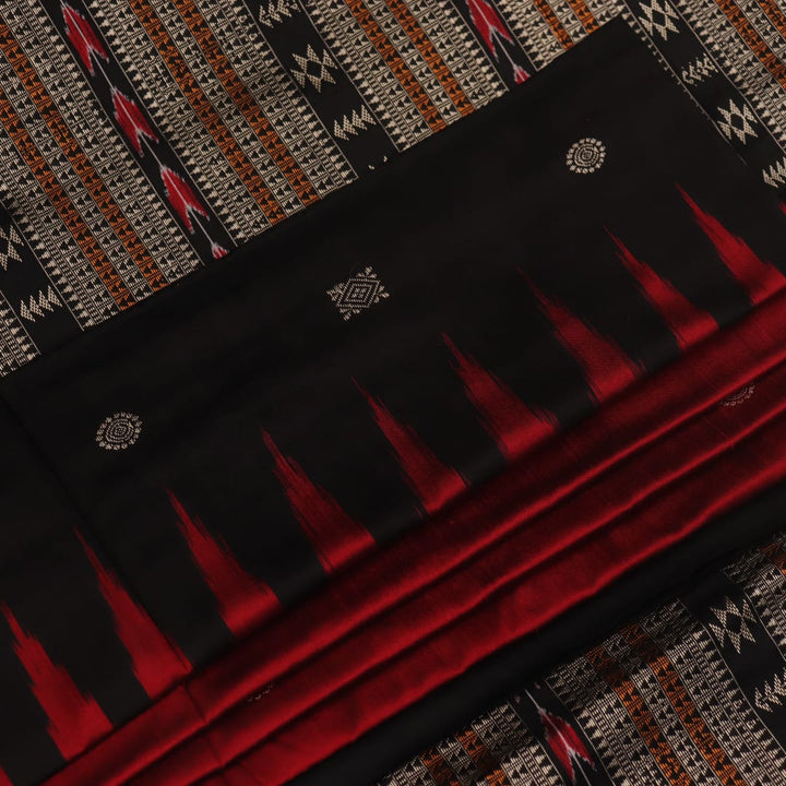 Close-up texture of handwoven Bomkai silk saree fabric: maroon and black threads forming butta pattern.