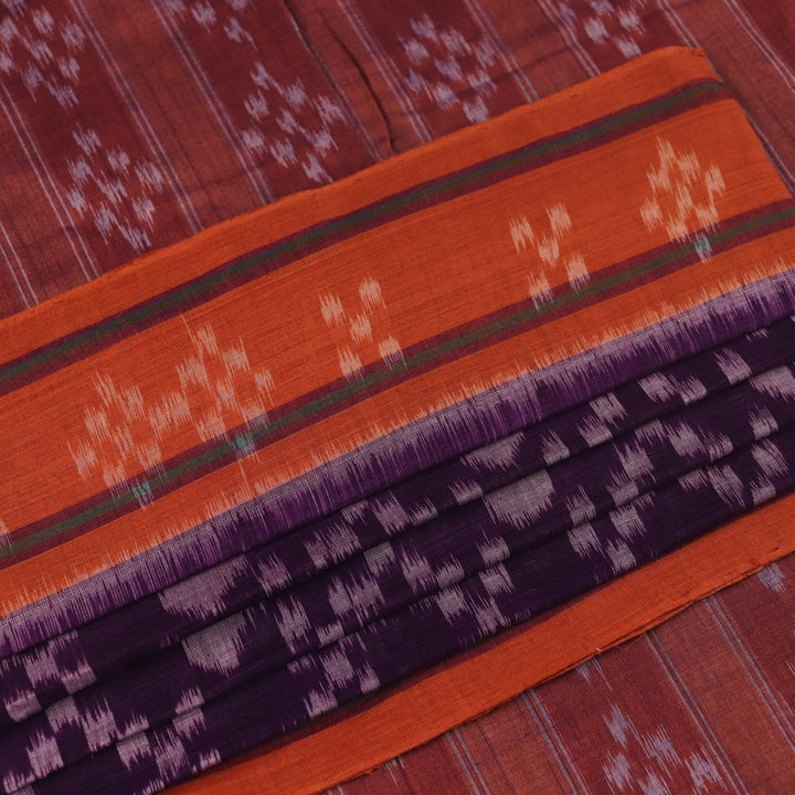 Violet & rust Sambalpuri cotton saree with motifs, elegantly draped.
