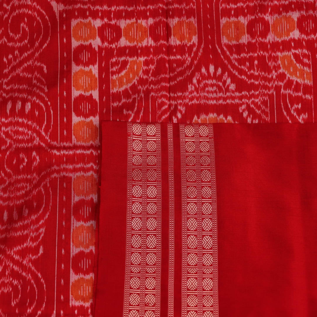 Close-up of multicolored silk Sambalpuri saree fabric showing intricate handloom weave texture.