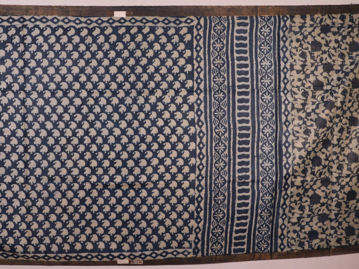 Close-up of blue printed Tussar silk saree fabric texture.