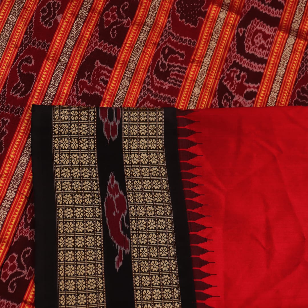 Close-up of black and red striped Sambalpuri silk saree's woven texture.