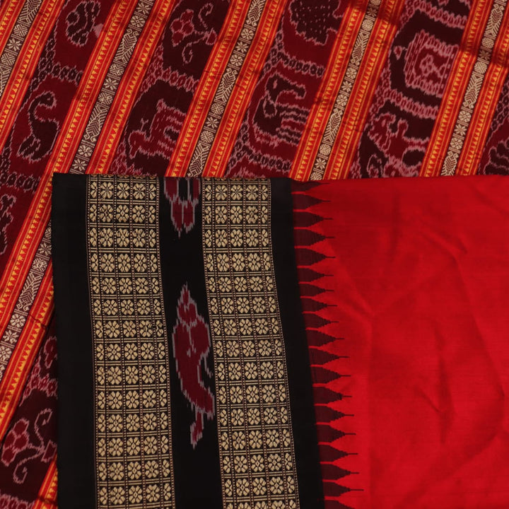 Close-up of black and red striped Sambalpuri silk saree's woven texture.