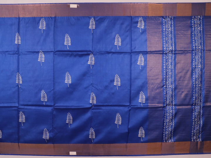 Close-up of blue printed Tussar silk handloom saree fabric texture.