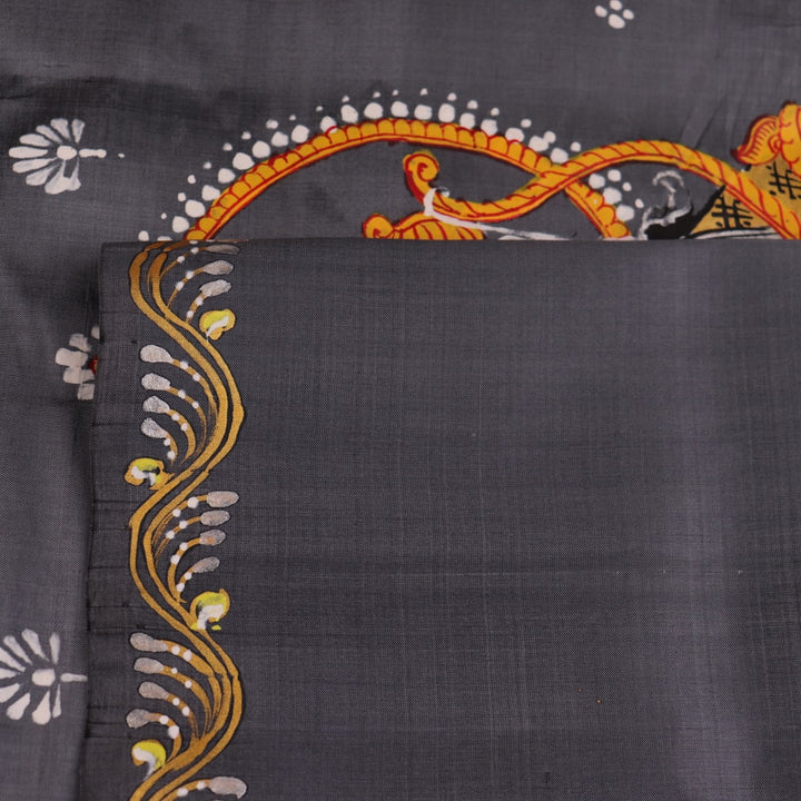 Close-up of handloom grey silk Patachitra saree fabric texture, revealing the intricate details of the hand-painted design.