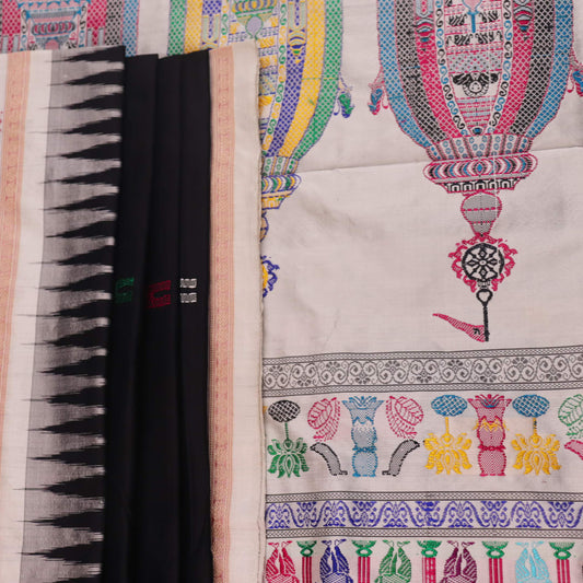 Close-up texture of black and white Bomkai silk saree with butta pattern.
