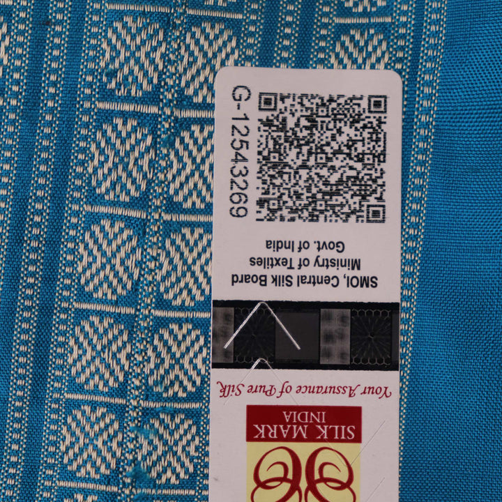 Close-up of multi-color Sambalpuri silk saree fabric showing texture and woven motifs; secondary color blue visible.