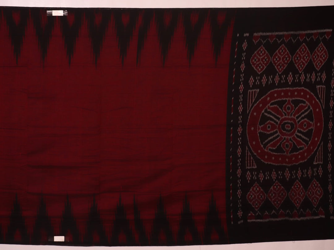 Gracefully draped maroon and black plain Sambalpuri cotton saree.