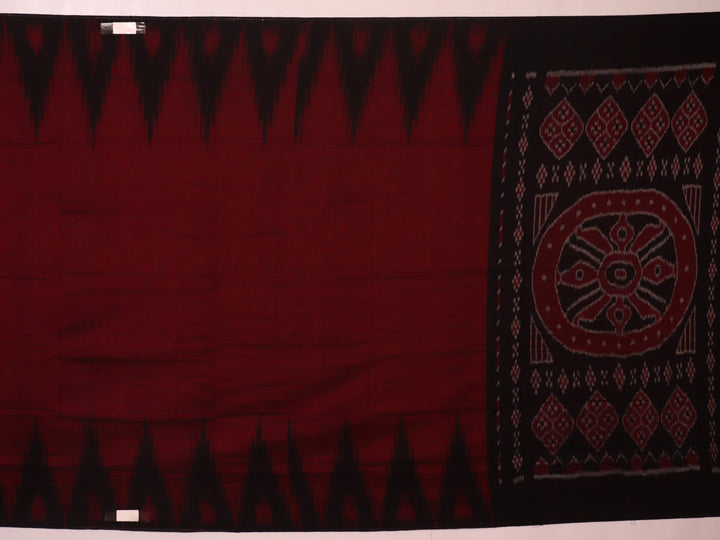 Gracefully draped maroon and black plain Sambalpuri cotton saree.