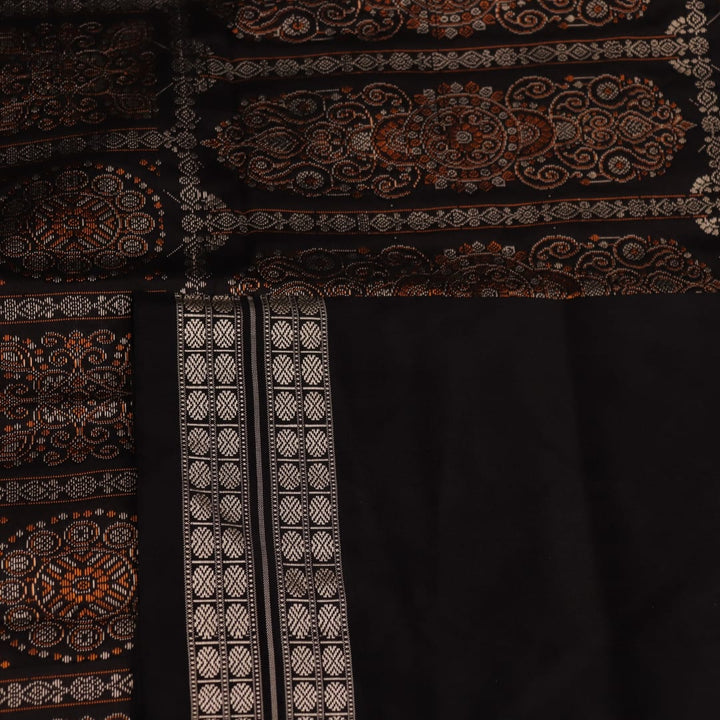Detailed close-up of the red and black Bomkai silk saree fabric texture, featuring a butta pattern.