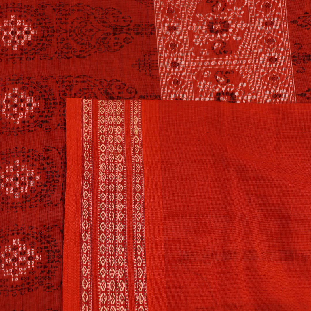 Full view of a black and orange Bomkai cotton handloom saree with butta pattern.