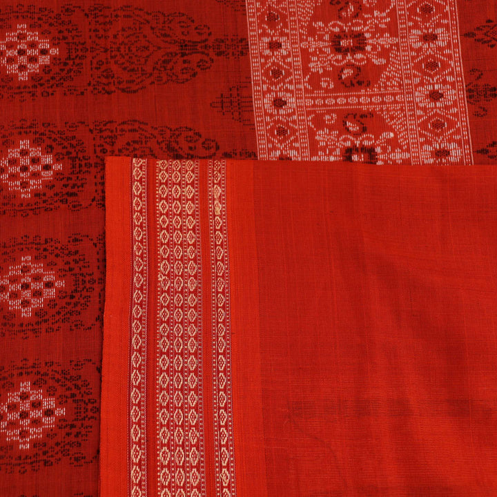 Full view of a black and orange Bomkai cotton handloom saree with butta pattern.