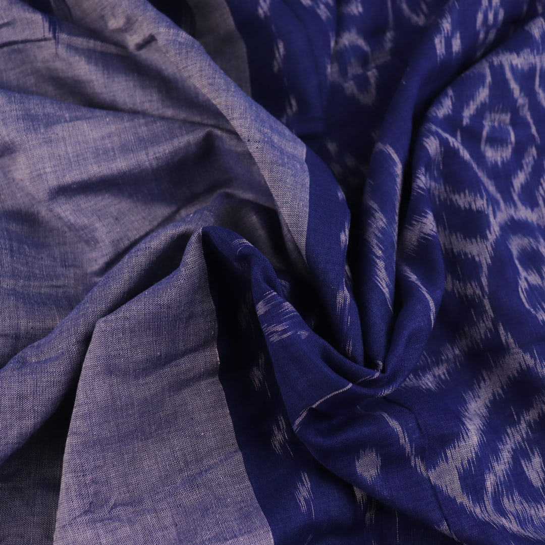 Blue plain Sambalpuri cotton saree styled, highlighting its simple elegance and drape.