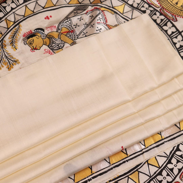 Close-up of white silk Patachitra saree, showcasing the handloom fabric's texture and subtle paint details.
