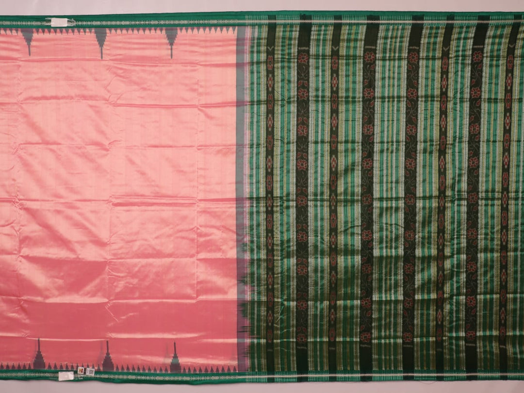 Close-up of the plain woven silk texture of a pink and green Sambalpuri saree.